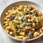 serving bowl of creamy garlic butter beef pasta with parsley