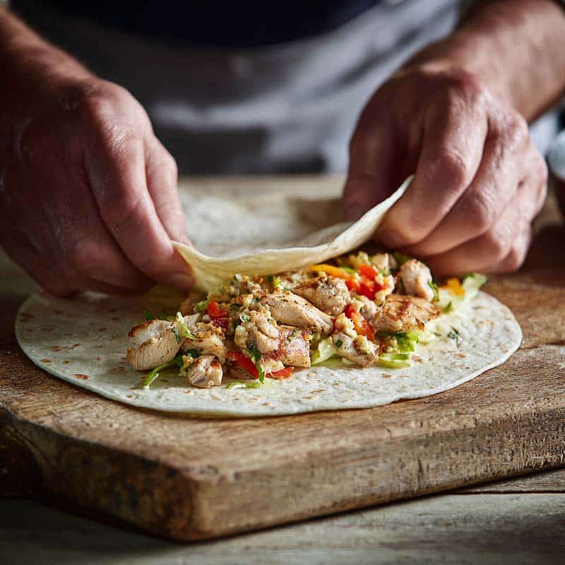 Assembling cheesy garlic chicken wrap