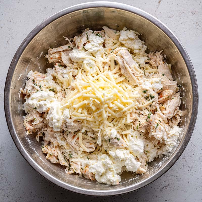 Mixing cheesy garlic chicken filling