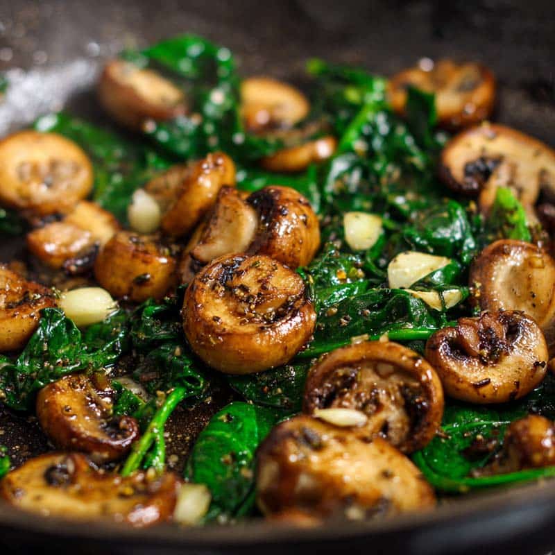 Sautéing spinach, mushrooms, and garlic for zucchini boat filling