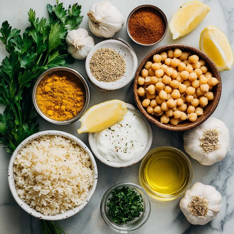 Ingredients for turmeric chickpea rice bowl laid out on white background