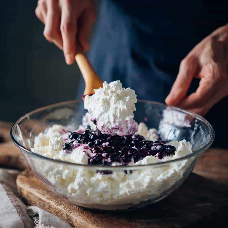 Folding blueberries into cloud bread mixture