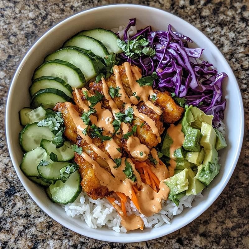 Chicken Bang Bang Bowl with sauce and fresh veggies