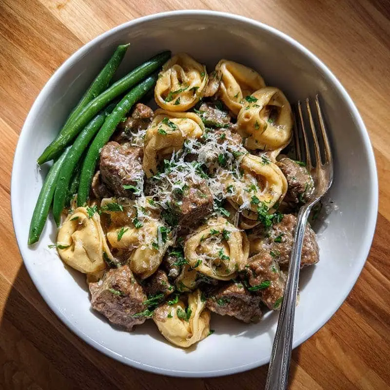 serving of creamy beef stroganoff tortellini with green beans