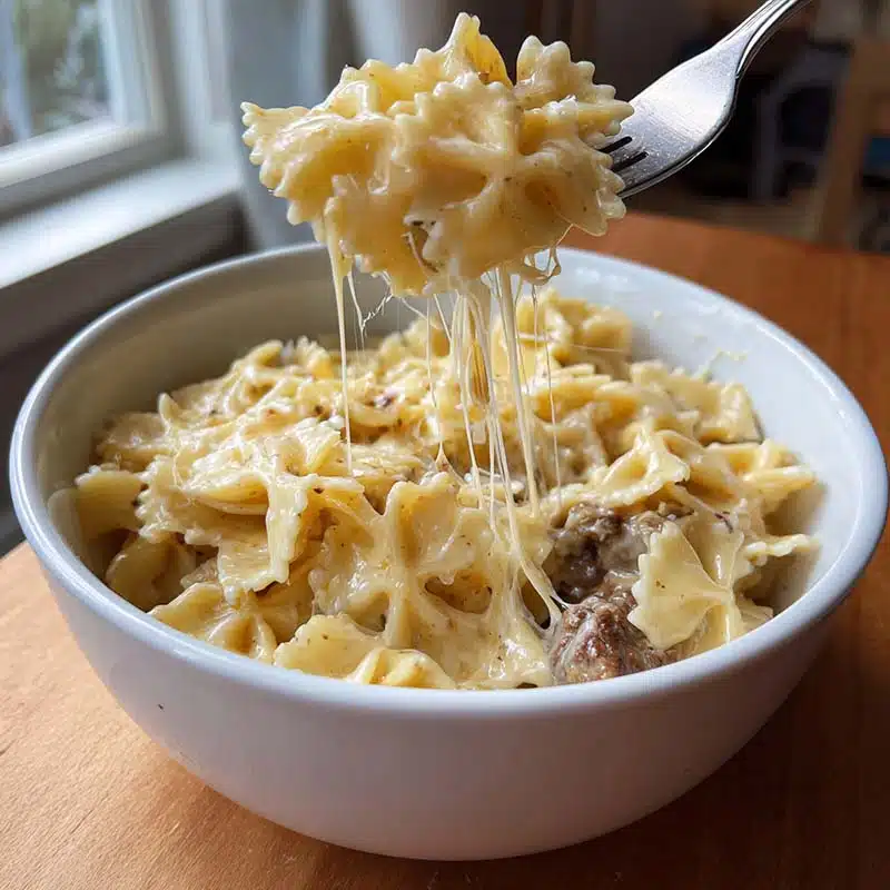Creamy Velveeta beef pasta with bowtie noodles served in a rustic bowl
