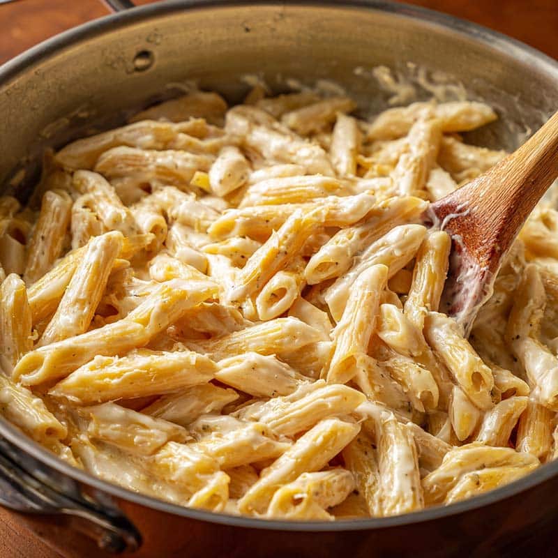 Stirring creamy pasta in the pot