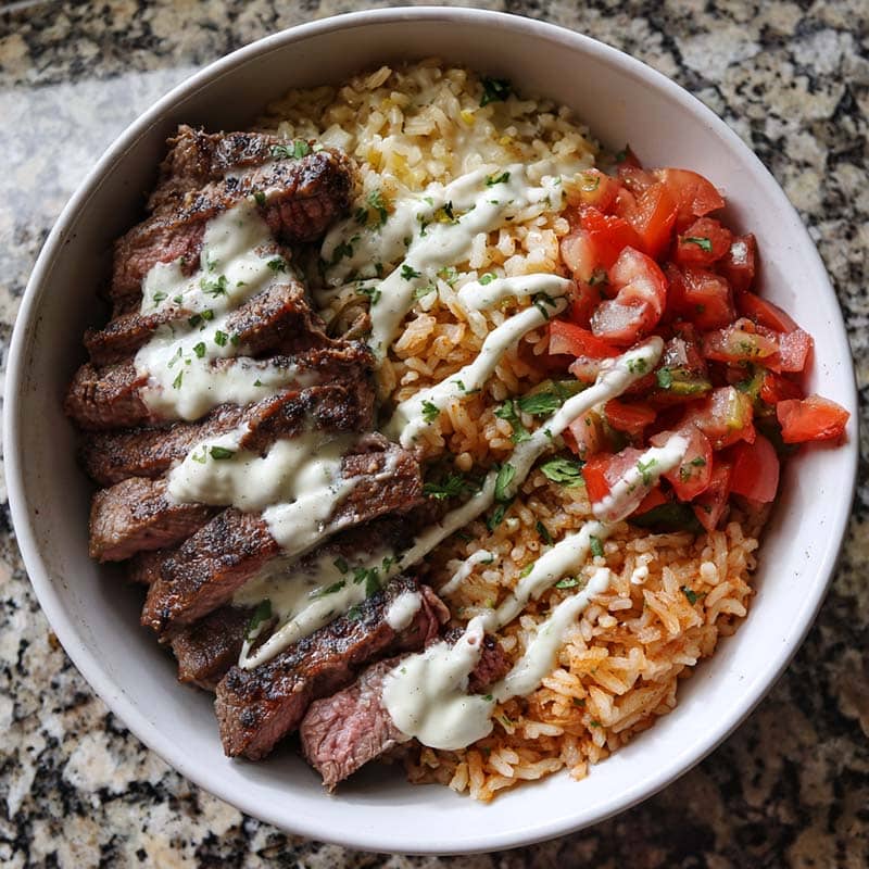steak and queso rice bowl in ceramic dish