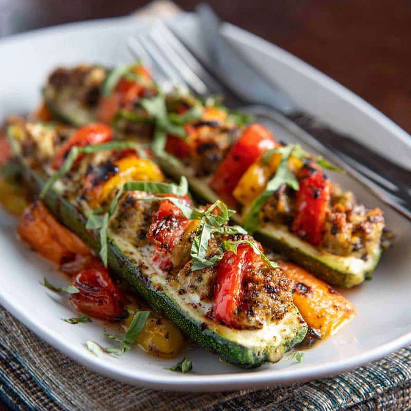 Recipe card for spinach mushroom and ricotta stuffed zucchini boats